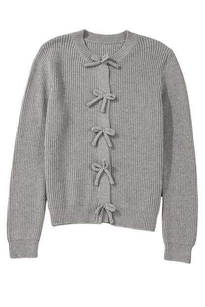 Gray ribbed sweater with decorative bows on a white background